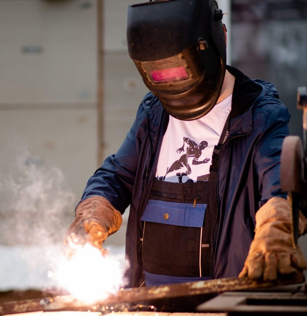 worker-welding-iron-rails-03 welding for custom iron rails